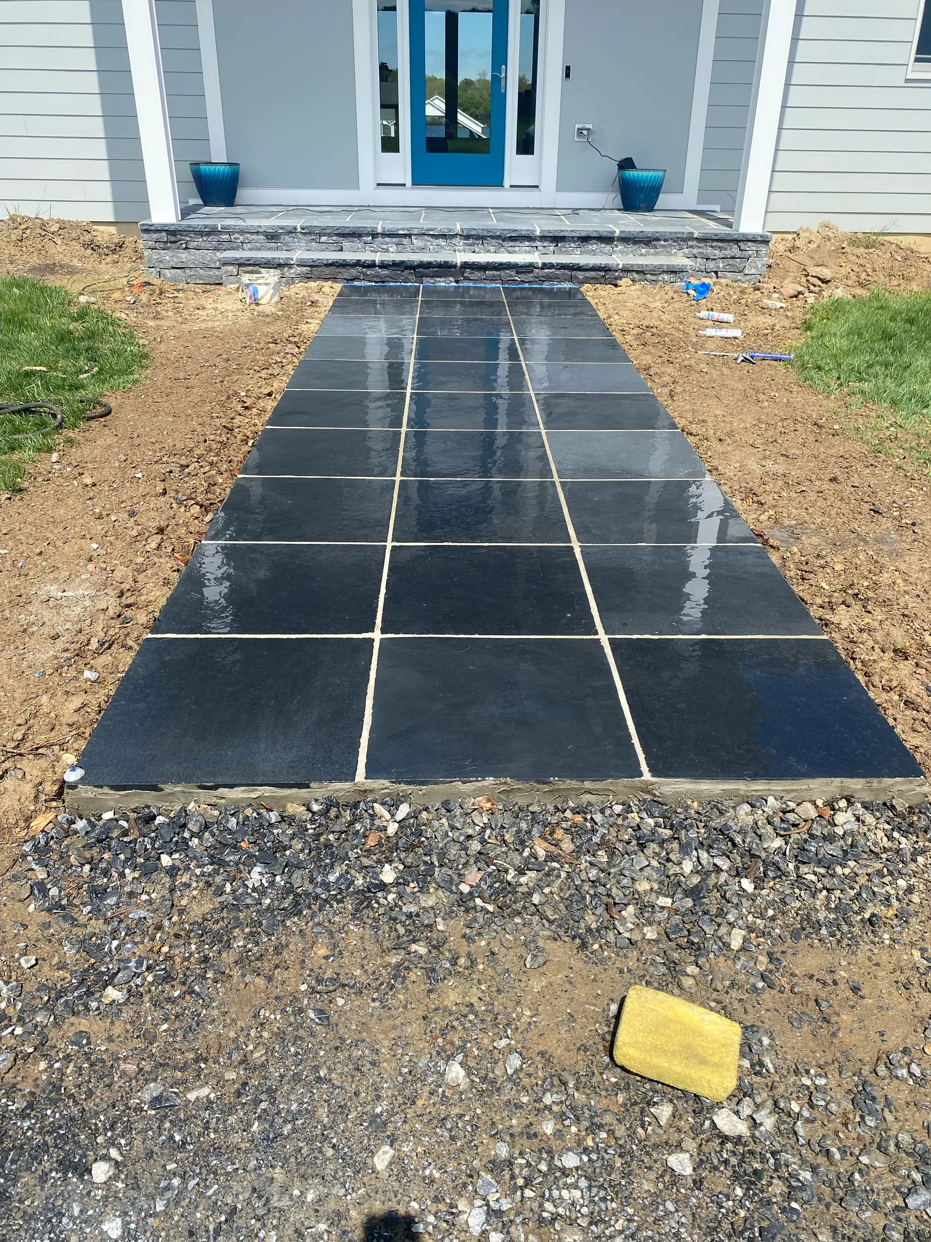 Black stone tile hardscaping walkway by DM Hardscapes